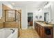 Elegant bathroom with dual vanity sinks, soaking tub, glass enclosed shower and walk in closet at 1055 Chelsey Way, Roswell, GA 30075