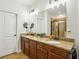 Elegant bathroom featuring dual sinks, a large mirror, and a separate glass-enclosed shower at 1055 Chelsey Way, Roswell, GA 30075