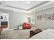 Relaxing bedroom showcases a comfortable seating area, neutral walls, and natural light from the window at 1055 Chelsey Way, Roswell, GA 30075