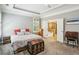 Inviting bedroom featuring neutral walls, a large bed, and an ensuite bathroom visible through open doors at 1055 Chelsey Way, Roswell, GA 30075