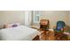 Charming bedroom featuring hardwood floors, a desk, and a comfortable chair, perfect for relaxation and work at 1055 Chelsey Way, Roswell, GA 30075