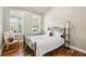 Cozy bedroom with hardwood floors, natural light, and a comfortable chair for relaxation at 1055 Chelsey Way, Roswell, GA 30075