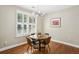 Cozy breakfast nook features a round table, shutters, and natural light at 1055 Chelsey Way, Roswell, GA 30075