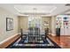 Formal dining room with tray ceilings, an elegant light fixture, and hardwood floors at 1055 Chelsey Way, Roswell, GA 30075