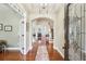 Elegant foyer with hardwood floors, glass paneled entry door, and an inviting arched doorway at 1055 Chelsey Way, Roswell, GA 30075