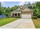 Charming home featuring a stone facade, well-manicured landscaping, and a spacious driveway leading to an attached garage at 1055 Chelsey Way, Roswell, GA 30075