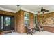 Inviting front porch with stone accents, comfortable seating, and a charming ceiling fan at 1055 Chelsey Way, Roswell, GA 30075