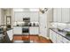 Bright kitchen featuring white cabinetry, stainless steel appliances, and granite countertops at 1055 Chelsey Way, Roswell, GA 30075