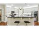 Modern kitchen featuring white cabinets, stainless steel appliances, and a convenient breakfast bar at 1055 Chelsey Way, Roswell, GA 30075