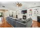 Spacious living room featuring built-in shelving, a cozy fireplace, and an expansive sectional sofa at 1055 Chelsey Way, Roswell, GA 30075