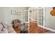 Inviting living room with glass coffee table and French doors leading to the entry at 1055 Chelsey Way, Roswell, GA 30075
