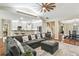 Open concept living room with a large sectional sofa, hardwood floors, and vaulted ceilings at 1055 Chelsey Way, Roswell, GA 30075