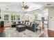 Open concept living room boasts a fireplace, large windows, and access to the kitchen at 1055 Chelsey Way, Roswell, GA 30075
