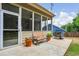 Screened patio showcasing a bench, potted plants, and grill, perfect for outdoor enjoyment and relaxation at 1055 Chelsey Way, Roswell, GA 30075