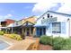 Street view with colorful buildings and lush greenery, with a sidewalk and manicured plants in the foreground at 1055 Chelsey Way, Roswell, GA 30075
