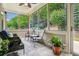 Cozy sunroom with ample seating, serene views, and plenty of natural light at 1055 Chelsey Way, Roswell, GA 30075