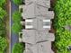 Overhead view of townhome roofs with dormer windows, lush trees, and nearby road at 11187 Calypso Dr # 12, Alpharetta, GA 30009