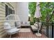 Cozy back deck featuring outdoor furniture, including a couch, chairs, and side table at 11187 Calypso Dr # 12, Alpharetta, GA 30009