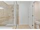 Bathroom featuring a glass-enclosed shower, with tiled walls, and a toilet next to a door at 11187 Calypso Dr # 12, Alpharetta, GA 30009
