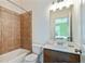 Bathroom with a tiled tub/shower, toilet, vanity with a sink, and a view of the bedroom at 11187 Calypso Dr # 12, Alpharetta, GA 30009