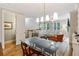 Chic dining area with glass table and view into the adjacent living room at 11187 Calypso Dr # 12, Alpharetta, GA 30009