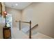 Upstairs hallway with neutral carpeting and a wooden railing leading to the bedrooms at 11187 Calypso Dr # 12, Alpharetta, GA 30009