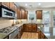 Well-appointed kitchen featuring granite countertops, stainless steel appliances, and ample cabinetry at 11187 Calypso Dr # 12, Alpharetta, GA 30009