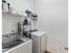 Laundry room with a washer and dryer, shelving, and ample storage space for laundry supplies at 11187 Calypso Dr # 12, Alpharetta, GA 30009