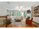 Inviting living room with hardwood floors, large sectional, and built-in shelving at 11187 Calypso Dr # 12, Alpharetta, GA 30009