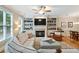 Cozy living room with fireplace, built-in bookshelves, and hardwood floors at 11187 Calypso Dr # 12, Alpharetta, GA 30009