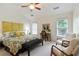 Bright main bedroom boasts vaulted ceiling, plush carpet, ceiling fan, and large windows at 11187 Calypso Dr # 12, Alpharetta, GA 30009