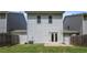 A simple backyard with a small patio, an air conditioning unit, and double doors at 118 Woodhouse Cir, Acworth, GA 30102