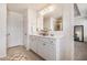 Bright bathroom featuring double sink vanity, large mirror, and white cabinets at 118 Woodhouse Cir, Acworth, GA 30102