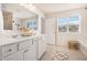 Bright bathroom featuring double sink vanity and natural lighting from the window at 118 Woodhouse Cir, Acworth, GA 30102