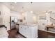 Open concept kitchen with island seating, stainless steel appliances, and a view of the adjacent living space at 118 Woodhouse Cir, Acworth, GA 30102