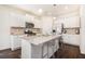 Bright kitchen featuring an island with seating, stainless steel appliances, and plenty of white cabinet storage at 118 Woodhouse Cir, Acworth, GA 30102