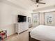 Bright main bedroom with a tray ceiling, a large window, neutral decor, and carpeted floor at 118 Woodhouse Cir, Acworth, GA 30102