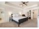 Comfortable main bedroom featuring neutral tones, a tray ceiling, and a cozy sitting area at 118 Woodhouse Cir, Acworth, GA 30102