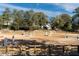 Spacious horse arena featuring jumps, surrounded by mature trees and fencing, with a charming home in the background at 331 Lakemoore Ne Dr # C, Atlanta, GA 30342