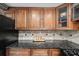 Kitchen featuring granite countertops, wooden cabinets, and a tiled backsplash at 331 Lakemoore Ne Dr # C, Atlanta, GA 30342
