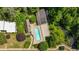 Aerial view of a sparkling community pool surrounded by greenery and next to a creek at 331 Lakemoore Ne Dr # C, Atlanta, GA 30342