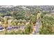 An aerial view shows a neighborhood with mature trees and well-maintained homes in a wooded setting at 100 Lantana Dr, Locust Grove, GA 30248