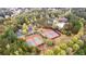 Aerial view showcasing community tennis courts, clubhouse, pool, parking, and surrounding landscape at 100 Lantana Dr, Locust Grove, GA 30248