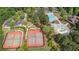 Aerial view showcasing the community pool, tennis courts, landscaping, and ample parking at 100 Lantana Dr, Locust Grove, GA 30248