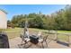 Back yard featuring an outdoor seating area with a patio, and a large open grassy area at 100 Lantana Dr, Locust Grove, GA 30248