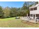 Spacious backyard with a patio, firepit, and mature trees, perfect for outdoor entertaining at 100 Lantana Dr, Locust Grove, GA 30248