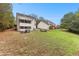 Large backyard with a fire pit, screened porch, mature trees, and plenty of space for outdoor activities at 100 Lantana Dr, Locust Grove, GA 30248