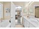 A well-lit bathroom featuring double sinks, and a soaking tub for a relaxing and spa-like experience at 100 Lantana Dr, Locust Grove, GA 30248