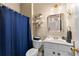 Cozy bathroom featuring a blue shower curtain, marble countertop and neutral walls at 100 Lantana Dr, Locust Grove, GA 30248