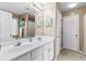 Bathroom featuring a double vanity, large mirror, and neutral color palette, creating a bright and inviting space at 100 Lantana Dr, Locust Grove, GA 30248